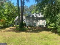 Charming two-story home with a well-manicured lawn and mature trees providing shade and privacy at 345 Kerrith Drive Dr, Stockbridge, GA 30281