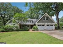 Charming home with white painted stone, shake accents, manicured lawn, and a two-car garage at 3612 Bill Gardner Pkwy, Locust Grove, GA 30248