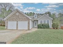 Charming single-Gathering home with stone accents, vinyl siding, attached garage, and well-maintained landscaping at 131 Meadowbrook Ln, Grantville, GA 30220