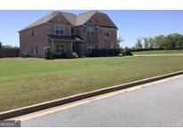 Beautiful two story brick home with manicured lawn and professional landscaping at 160 Elysian Dr, Fayetteville, GA 30214