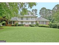 Charming two-story home with a well-manicured lawn, brick accents and a second story balcony at 550 Hawthorne Dr, Fayetteville, GA 30214
