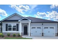 Charming single-story home with a two-car garage, black shutters, and stone veneer against light siding at 139 Oakchase Park Ln, Hampton, GA 30228