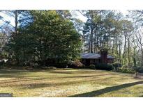 Charming single-story home with a large front yard and mature trees providing privacy at 200 Lee St, Jonesboro, GA 30236