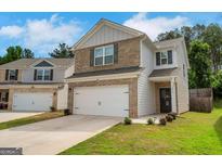 Charming two-story home featuring a two-car garage and well-maintained lawn at 10814 Wheeler Trce, Hampton, GA 30228