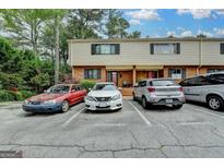 Exterior view of a multi-Gathering home with brick and siding, surrounded by trees and parked cars at 3346 Northcrest Rd # A, Atlanta, GA 30340