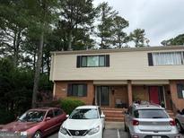 Charming townhome featuring brick and siding, complemented by mature trees and parking at 3346 Northcrest Rd # A, Atlanta, GA 30340