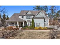 Charming two-story home with well-maintained landscaping, light-blue paint, and welcoming curb appeal at 240 Sturry Dr, Mcdonough, GA 30252
