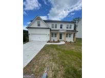 Charming white two-story home with a well-manicured lawn and a two-car garage at 129 Silvercrest Dr # 57, Acworth, GA 30101