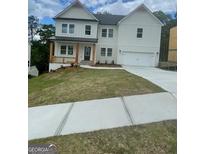 Beautiful two-story home with white siding, covered front porch, and a two-car garage at 149 Silvercrest Dr # 58, Acworth, GA 30101