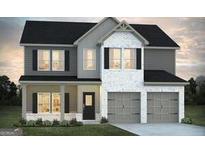 Charming two-story home featuring a covered front porch and a two-car garage, combining modern design with curb appeal at 506 Alford Cv # 89, Fairburn, GA 30213