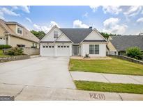 Charming home with a well-manicured lawn, three-car garage, and inviting curb appeal at 240 Turnbridge Cir, Peachtree City, GA 30269