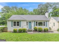 Charming one-story home featuring a manicured front lawn and inviting light blue front door at 489 Radar Dr, Hapeville, GA 30354