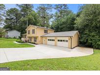Inviting two-story home with a spacious driveway and attached two car garage at 423 Mephisto Cir, Lawrenceville, GA 30046
