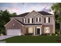 Charming two-story home featuring a brick and siding exterior, well-manicured lawn, and a two-car garage at 817 Dobby Way # 96, Mcdonough, GA 30252