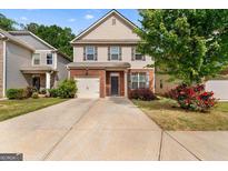 Charming two-story home featuring a brick facade and well-manicured front lawn at 11755 Lovejoy Crossing Blvd, Hampton, GA 30228