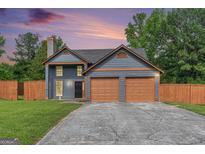 Charming two-story home features a spacious two-car garage and beautifully maintained lawn at 548 Thomas Downs Way, Jonesboro, GA 30238