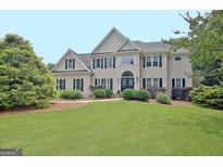 Well-maintained two story home with beautiful yard, landscaping, and traditional design at 104 Hidden Springs Ln, Peachtree City, GA 30269