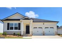 Charming single-story home featuring a two-car garage, black shutters, and a well-maintained lawn and landscaping at 147 Oakchase Park Ln, Hampton, GA 30228