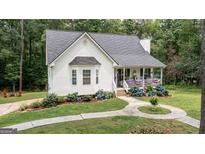 Charming one-story home with beautiful curb appeal, a welcoming front porch and landscaped flowerbeds at 10 Stagg Trce, Social Circle, GA 30025
