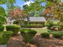 Charming single-story home featuring mature landscaping, a manicured lawn, and lovely curb appeal at 135 Acorn Dr, Mcdonough, GA 30253