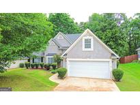 Charming home with well-maintained landscaping, and a two-car garage at 329 Royal Crescent Way, Stockbridge, GA 30281