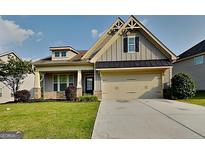 Charming two-story home with a well-manicured lawn, attached garage, and a welcoming front porch at 471 Lanier Ct, Hiram, GA 30141