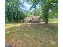 Charming home with a combination of stone and siding, nestled among mature trees at 366 Montgomery Pl, Jonesboro, GA 30238