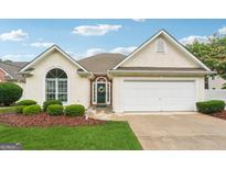 Charming single-Gathering home with well-maintained lawn, attached garage, and inviting front entrance at 412 Rock Creek Dr, Peachtree City, GA 30269
