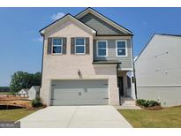 New two-story home with a two car garage, brick, siding, and professionally landscaped front yard at 42 Avian Way # 128B, Auburn, GA 30011