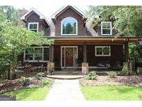 Charming brown home with landscaped front yard, inviting covered porch, and stone accents at 99 Landers Ne Rd, Rydal, GA 30171