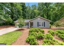Charming single-story home featuring a well-maintained yard and a cozy front porch at 810 Bedford Park, Peachtree City, GA 30269