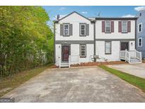 Charming townhome featuring a front yard with a concrete driveway at 2049 Charter Ln, Lithonia, GA 30058