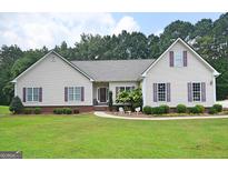 Charming ranch-style home with well-manicured lawn, colorful shutters, and inviting curb appeal at 2204 Happy Hollow Se Ct, Conyers, GA 30094