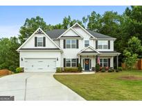 Charming two-story home with a well-manicured lawn, two car garage and tasteful landscaping at 8 Saint Charles Ave, Sharpsburg, GA 30277