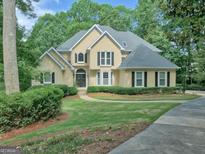 Charming two-story traditional home with mature landscaping and a well-manicured lawn at 307 Worthing Ln, Mcdonough, GA 30253