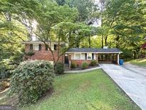 Charming brick home with well-maintained lawn and carport at 3158 Wisteria Way, East Point, GA 30344