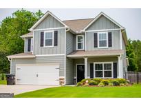 Charming two-story home with gray siding, black shutters, and a well-manicured lawn at 309 Dean Ct, Temple, GA 30179