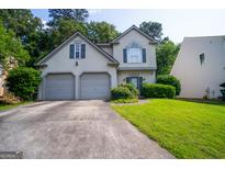 Charming two-story home featuring a well-maintained lawn, two-car garage, and neutral exterior paint at 2938 Cottesford Se Way, Smyrna, GA 30080