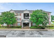 Attractive multi-story condo complex featuring well-maintained landscaping and covered entry at 12303 Waldrop Pl, Decatur, GA 30034