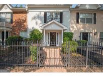 Charming multi-Gathering home featuring a gated front entrance and landscaped yard at 482 N Jeff Davis Dr, Fayetteville, GA 30214