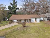Charming ranch-style home featuring covered carport and a quaint front porch swing at 108 Adrian Dr, Stockbridge, GA 30281