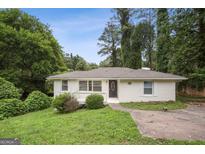 Charming one-story home featuring a freshly painted exterior and a welcoming front porch at 1854 Shadydale Se Ave, Atlanta, GA 30315