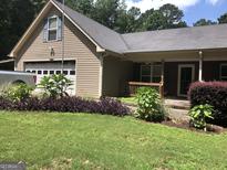 Charming home with a well-maintained lawn, garage, and welcoming front porch at 1744 Campbell Rd, Covington, GA 30014