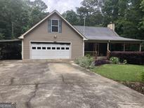 Charming single-story home featuring a two-car garage, covered porch, and a well-maintained landscaped yard at 1744 Campbell Rd, Covington, GA 30014