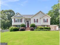 Charming two-story home with well-manicured lawn and cozy red shutters at 230 Cobblestone Ln, Mcdonough, GA 30252