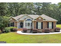 Charming brick and siding home with manicured landscaping and a welcoming entrance at 100 Riveredge Dr, Mcdonough, GA 30252