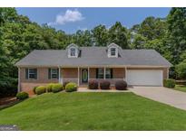 Charming single-story brick home with a well-maintained front yard and inviting entrance at 225 Chinns Way, Hampton, GA 30228