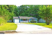 Charming one-story home with blue siding, red shutters, and a welcoming front porch at 1183 Iron Gate Blvd, Jonesboro, GA 30238