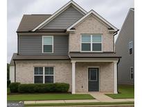 Charming two-story home with a combination of brick and siding, complemented by a well-maintained lawn at 1317 Rosemary Ln # 65, East Point, GA 30344