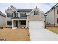 Charming two-story home featuring a two-car garage, neutral brick, and black shutters at 3468 Jasmine Sw Way, South Fulton, GA 30331
